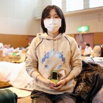 Женщина (32 года) держит в руках новый сотовый телефон, подаренный старшим братом. Оцути, префектура Иватэ. 9-е апреля 2011 г.