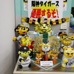 Манэки-нэко, декорированные в цвета и униформу бейсбольной комады "Тигры Хансина", за которую болеет весь Кансай и одним из спонсоров которой является банк-собственник музея