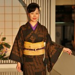 Фиолетовый воротник нижнего кимоно и такого же цвета обвязка пояса оби-дзимэ, что называется, вносят некое оживление в сдержанную общую гамму